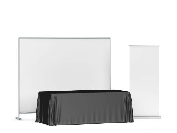 istock Blank tradeshow tablecloth with roll-up banners aside 1247940277