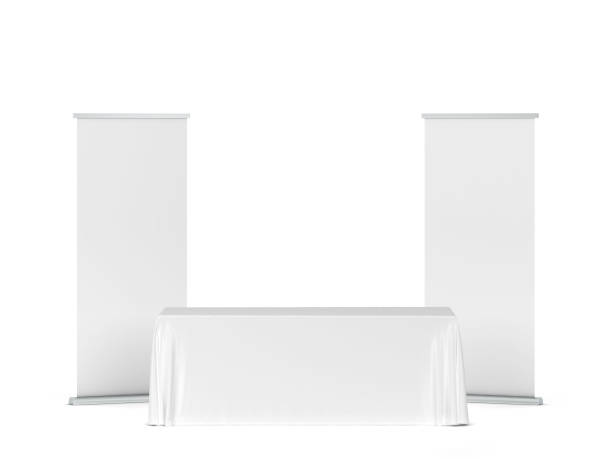 istock Blank tradeshow tablecloth with roll-up banners aside 1247940287