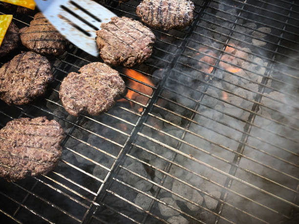 istock Hamburgers cooking on a hot bbq grill. 1247950046