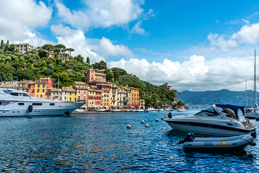 Portofino, Italy - May 27, 2014: The beautiful Portofino panorama with colorfull houses, luxury boats and yacht in little bay harbor. A vacation resort with celebrity visitors. Liguria, Italy