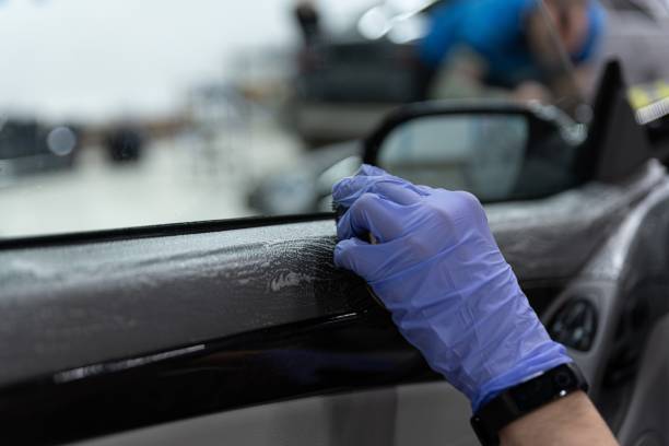 istock Car detailing worker cleaning car interior doors 1247963729