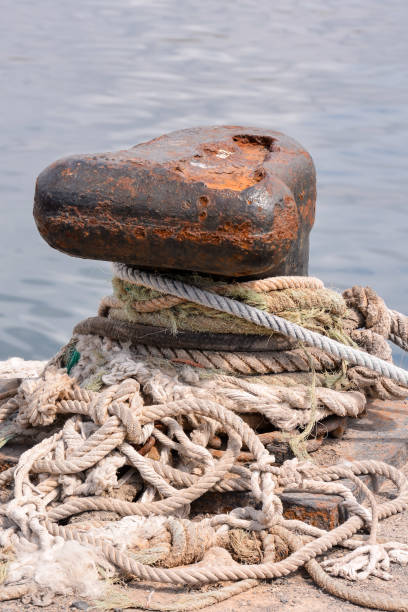 istock Rusty metal mooring bolard for big ship 1247964785