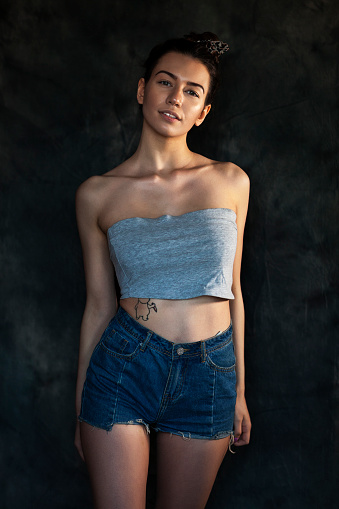 Portrait of a young woman in blue jeans shorts