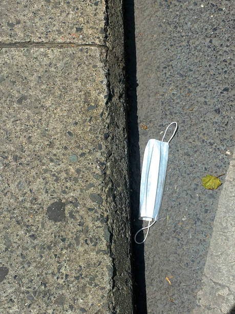 istock Used medical mask on the sidewalk 1247974377