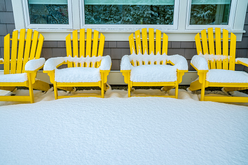 Snow encrusted Adirondack chairs on Vancouver Island, British Columbia