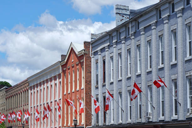 istock old building with row of Canadian red and white maple leaf flags 1247988629
