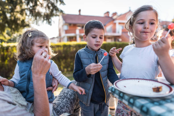 istock Grandmother and kids in back yard on sunny day 1248005609