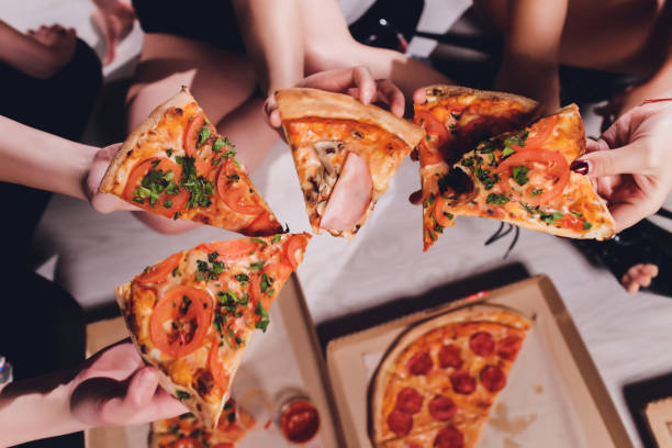istock Five young women Eating Pizza at home. 1248011952