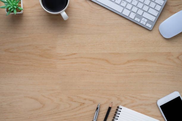 istock Workspace in office with wood table. Top view from above of keyboard with notebook and coffee. Desk for modern creative work of designer. Flat lay with blank copy space. Business and finance concept. 1248036883