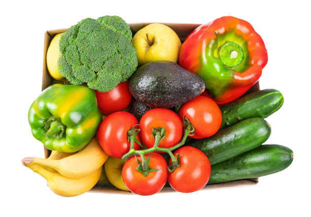 istock Different vegetables, fruits in cardboard box on white, top view. 1248043249