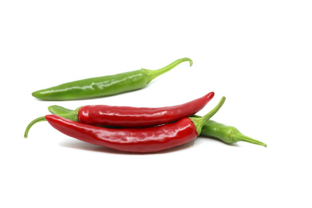 istock Red pepper and green pepper isolated in white background 1248043303