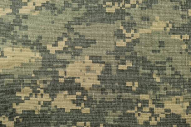 istock Universal camouflage pattern, army combat uniform digital camo, USA military ACU macro closeup, detailed large rip-stop fabric texture background, crumpled, wrinkled, foliage green, yellow desert sand tan, urban gray grey NYCO, nylon, cotton, horizontal t 1248047303