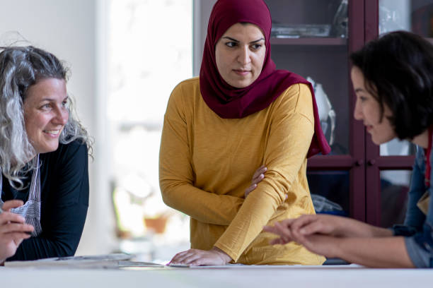 istock Multi-ethnic group of artists reviewing design plans for a textile project 1248049718