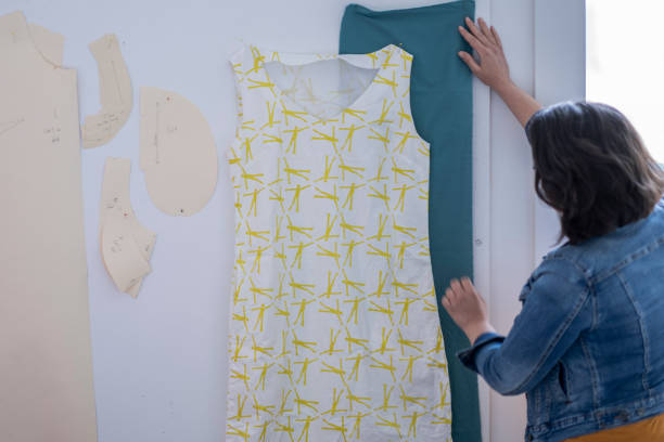 istock Female artist holding up fabric in studio 1248049766