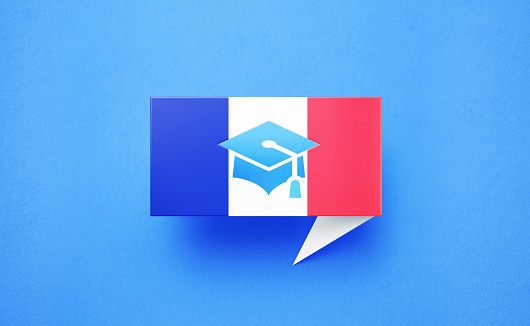 Graduation cap symbol on a speech bubble textured with French flag over blue background. Horizontal composition with copy space. Front view. Study in France concept.
