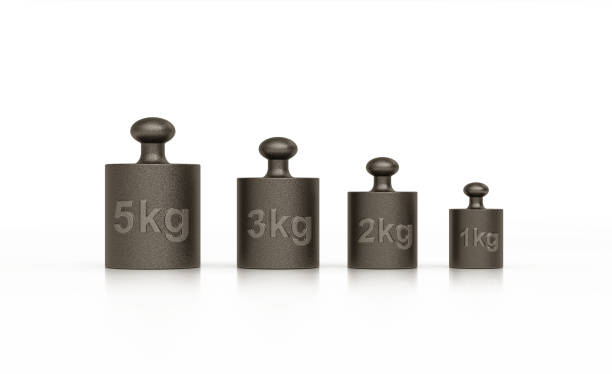 Five metal weights made of iron in a row on white  background. Horizontal composition with clipping path and copy space. Front view.