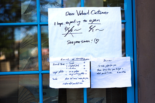 Santa Fe, NM: A reopening sign on a Japanese restaurant window during the pandemic in downtown  Santa Fe reading, in part: Dear valued customer, I hope expecting to open 6/1. See you soon!”
