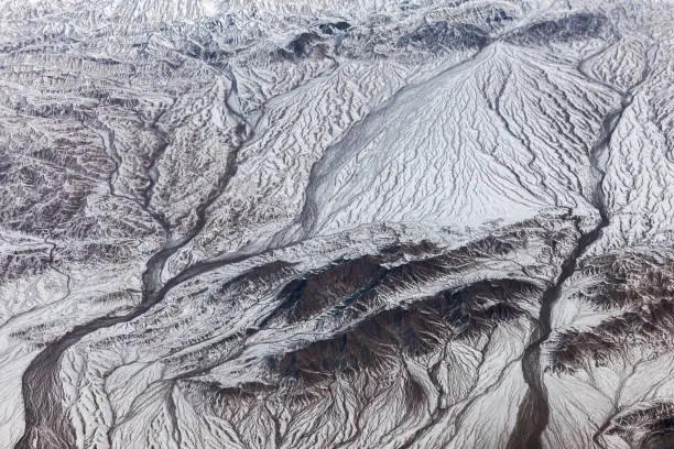 Aerial view of Tibet and Taklamakan Desert in China, valleys and rivers. Nikon D3x.