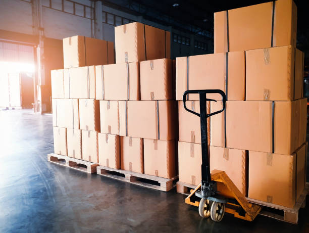 Stack of shipments boxes on wooden pallets at interior warehouse storage. Stack of shipments boxes on wooden pallets at interior warehouse storage. Cargo export. Warehouse industry logisics and transport. pallet industrial equipment photos stock pictures, royalty-free photos & images