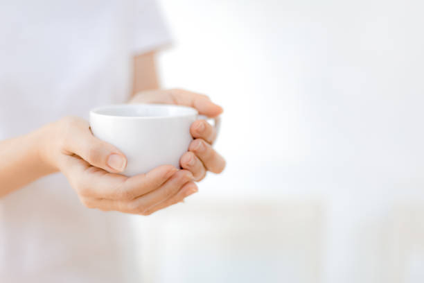 istock Woman hands holding white coffee cup 1248066283