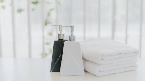 istock Shampoo and shower cream bottle with towel 1248066297