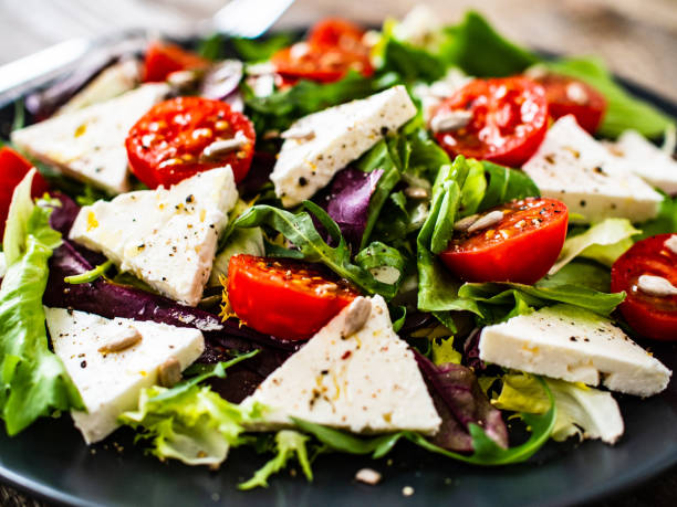 istock Greek salad on wooden table 1248073310