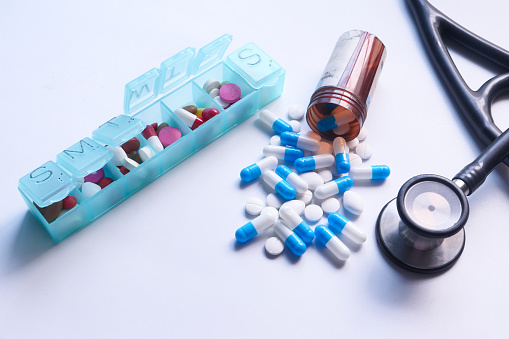 Close up of colorful capsule , pill box and stethoscope on white background ,