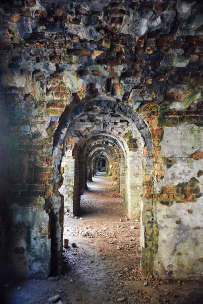 istock Many stone doorways going one after another in perspective in underground catacombs 1248086054