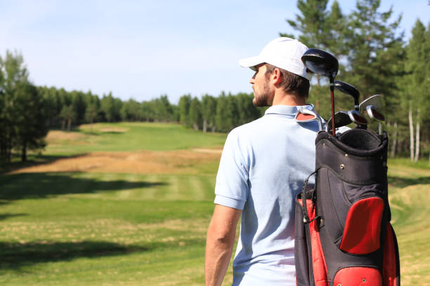 istock Golf player walking and carrying bag on course during summer game golfing. 1248087954