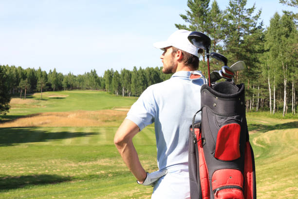 istock Golf player walking and carrying bag on course during summer game golfing. 1248088079