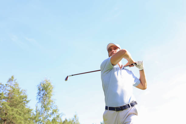 istock Golfer hitting golf shot with club on course while on summer vacation. 1248088098