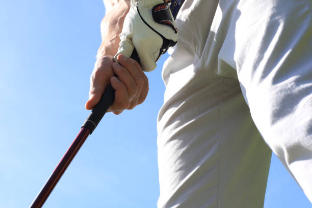 istock Golfer wearing a golf holding a putter. 1248088126