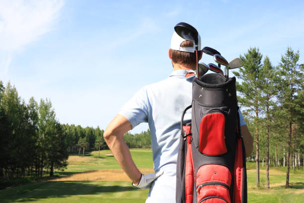 istock Golf player walking and carrying bag on course during summer game golfing. 1248088145