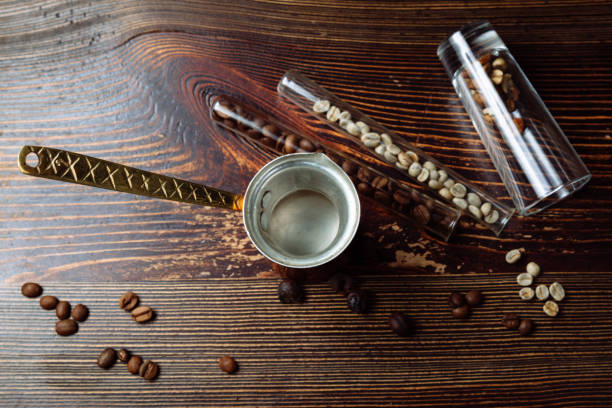 istock Coffee cezve and coffee beans on wooden background 1248097379