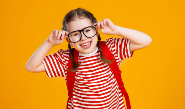 istock Cheerful smart schoolgirl adjusting glasses 1248104651
