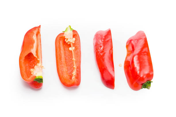 Colored bell peppers on old wooden table.