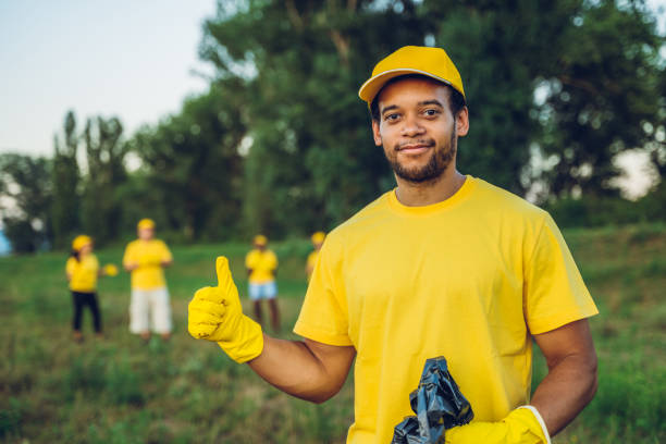 Black Man Picking Up Trash In Own Yard Black Man Picking Up Trash Stock Photos, Pictures & Royalty-Free Images