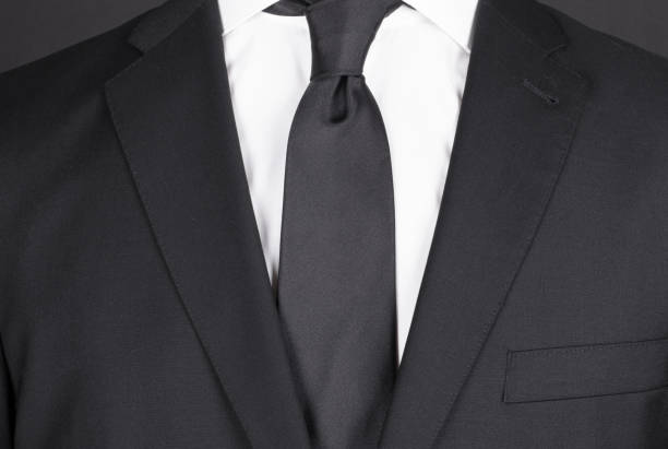 istock Man in a black suit with black tie, close-up 1248117465