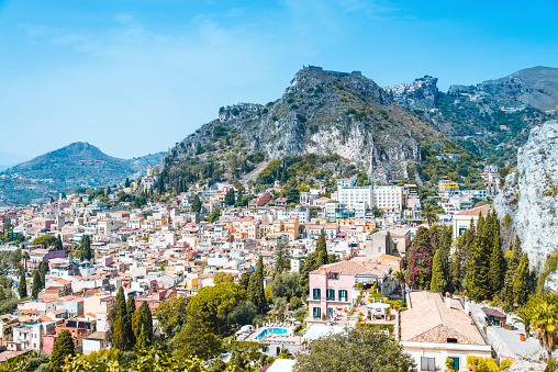 Aerial view overlooking the city of Taormina in Sicily, Italy. Seen a hot summer day.