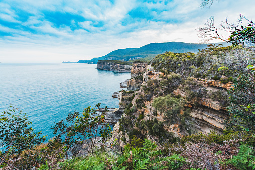 The rocky coastline at Eaglehawk Neck in Tasmania, Australia, during a late afternoon in the summer.