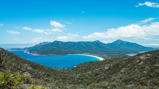 The white sand beach at the Wineglass Bay, Freycinet Peninsula, Tasmania, Australia, is shaped as a half moon.