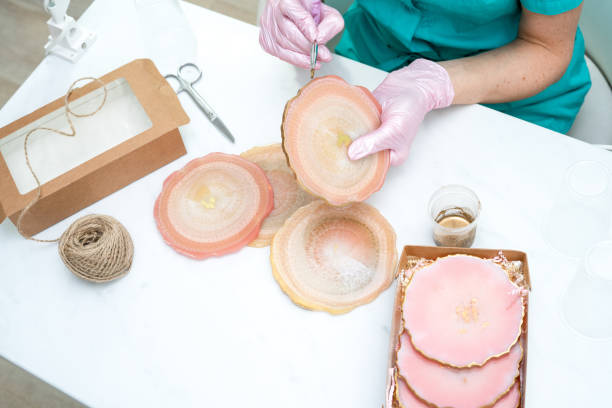 istock Creativity and craft. A young girl creates coasters from resin. Gift wrapping. Decorative packaging. Idea for business. Remote work, work at home. Art coasters. 1248122466