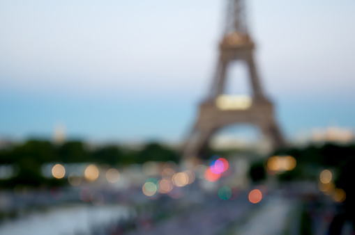 Blurred background silhouette eiffel tower in Paris with defocus bokeh and sunset light