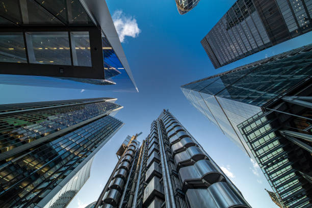 Looking directly up at the skyline of the financial district in central City of London on a bright sunny afternoon - creative stock image stock photo