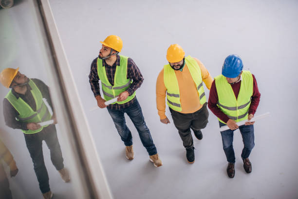 istock Male architects standing at construction site indoors 1248135363