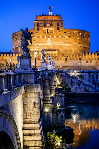 Rome, Italy, January 30 -- The evening lights illuminate the Tiber river, Castel Sant'Angelo and the homonyms bridge. Built around 123 AD as a sepulcher for Emperor Hadrian and his family, the current Castel Sant'Angelo was used as a fortress, prison and refuge by the Popes. It is currently owned by the Italian state and is used for visits and cultural events. Image in HD format.