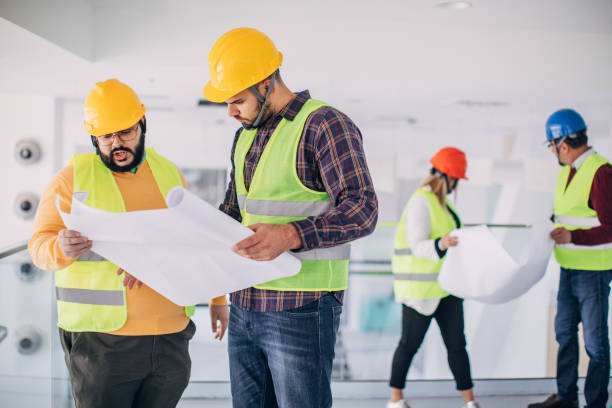 istock Group of architects and engineers looking at building plans 1248135885