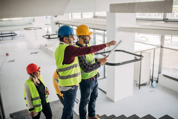istock Architects walking and discussing building plans at construction site 1248136204