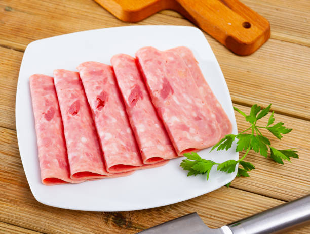 istock Sliced ham on wooden background 1248136312