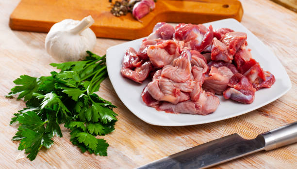 istock Raw chicken gizzards with greens and spices 1248136327